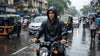 Best raincoat for bikers in India 2026 - rider wearing waterproof jacket on motorcycle in Mumbai monsoon rain