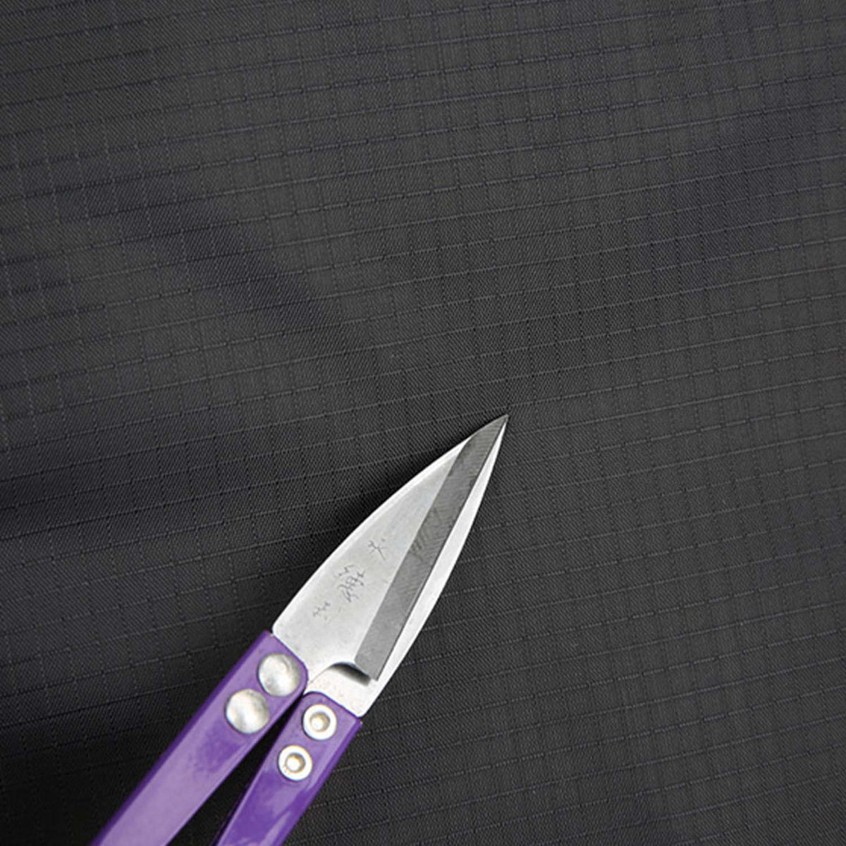 Close-up of Venzina nylon backpack fabric, durable material detail