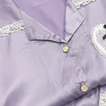 Lavender satin night suit for women, close-up of collar, lace trim and gold buttons