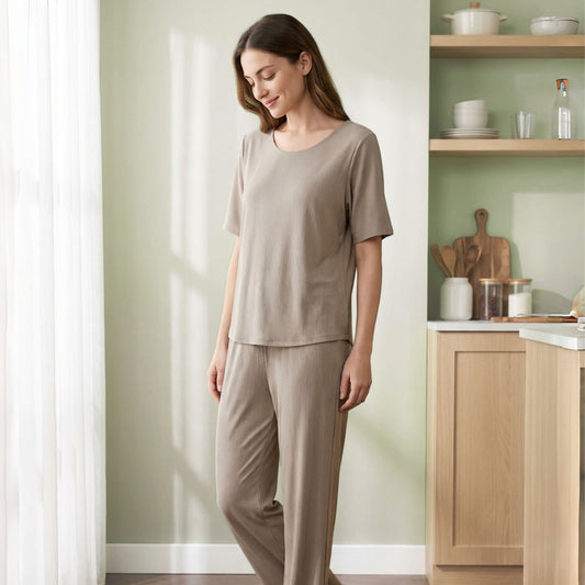 Venzina beige ribbed ladies nightwear set worn indoors, side view near kitchen shelves showing relaxed drape