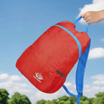 Venzina lightweight foldable backpack being carried by hand, waterproof travel daypack