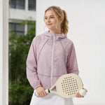 Venzina lilac hooded uv jacket women, outdoor side pose holding paddle and ball near greenery