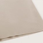 Venzina mens pyjamas close-up of beige ribbed fabric laid flat, showing fine knit texture and clean hem edge