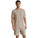 Venzina mens pyjamas worn by male model, beige ribbed short-sleeve top and shorts, front view, clean studio background