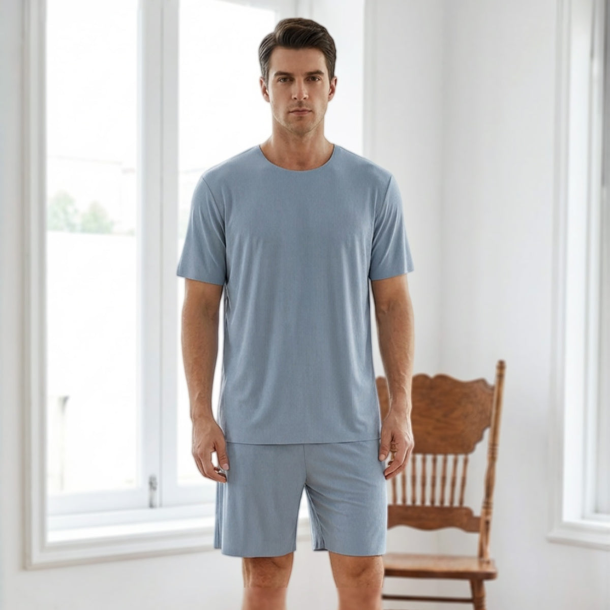 Venzina mens pyjamas worn by male model, front view of light blue ribbed short-sleeve set in a bright indoor room