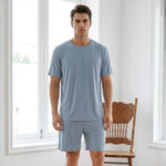 Venzina mens pyjamas worn by male model, front view of light blue ribbed short-sleeve set in a bright indoor room