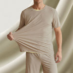 Venzina night suit for men worn by male model, front view showing beige ribbed top stretched by hand against soft studio backdrop