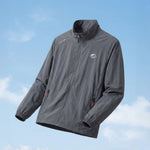 Venzina sun protection jacket in grey, angled flat lay with stand collar and zip pockets on sky backdrop