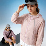 Venzina sun protection jacket women in blush pink, 3/4 close-up wearing cap with sunglasses, blue sky backdrop