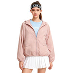 Venzina sun protection jacket women worn front view, soft pink hooded jacket paired with blue top and white skirt on studio white background