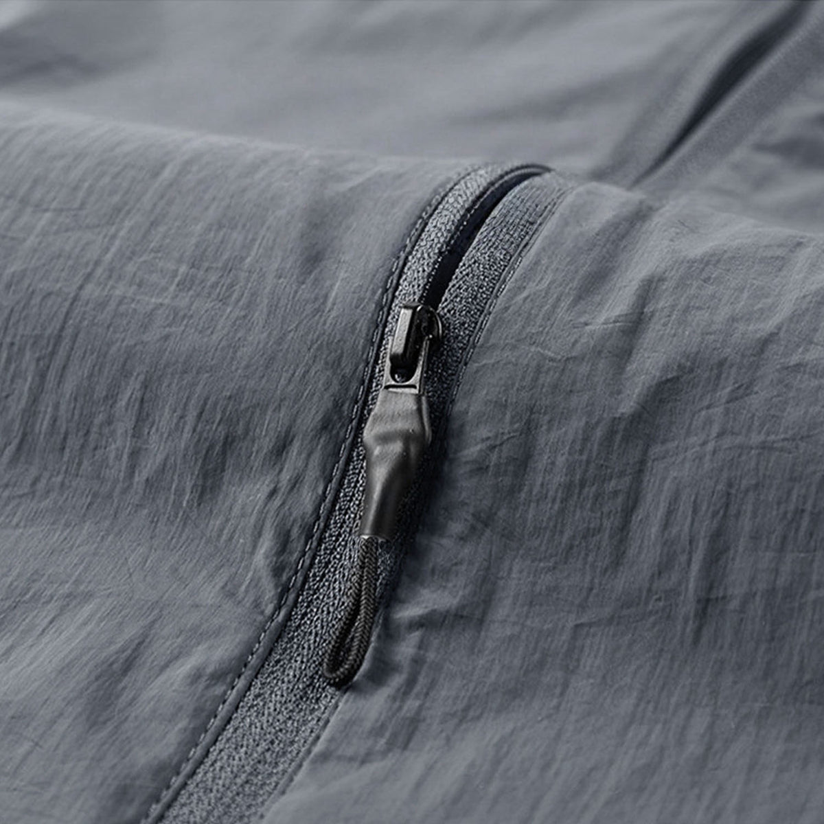 Venzina sunscreen jacket close-up of grey fabric zipper pocket and seam detail