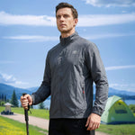 Venzina sunscreen jacket in grey worn hiking, three-quarter view with trekking pole, tent and mountains