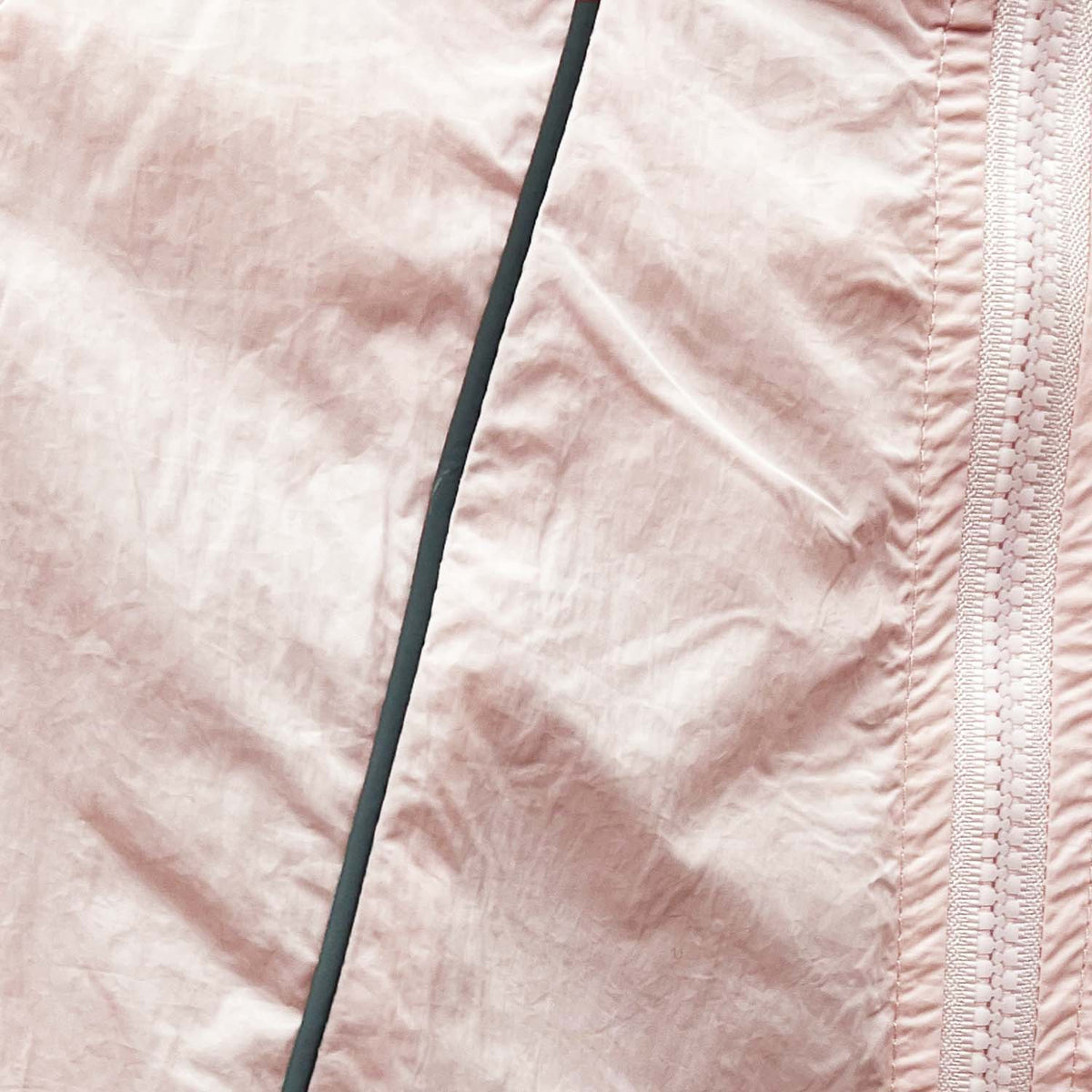 Venzina uv jacket women close-up, blush fabric texture with zipper tape and seam stitching detail