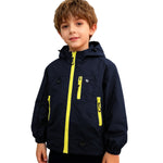 Boy wearing royal blue Venzina waterproof hooded windbreaker jacket with yellow zippers on white background