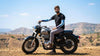Man riding a motorcycle wearing sun protection arm sleeves beside arm sleeves and face covers displayed outdoors