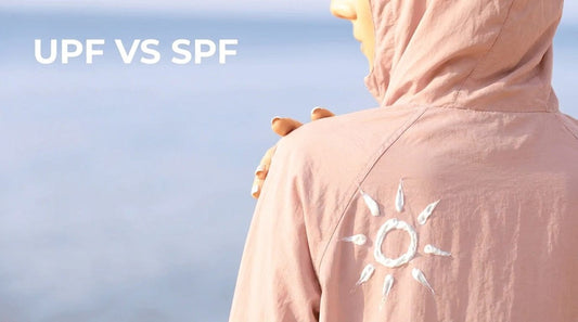 UPF vs SPF comparison infographic — UPF 50+ blocks 98% UV through fabric, SPF 30 extends burn time 30x on skin 
