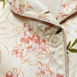 Floral women’s night suit button and collar detail on beige fabric