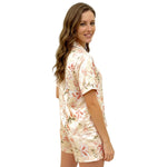 Floral women’s night suit worn by model, side view on white background