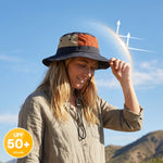 Venzina Lightweight Sun Hat worn by woman outdoors with wide brim and adjustable chin strap