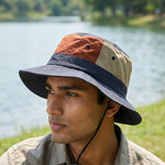 Venzina Outdoor Sun Hat worn by man near a lake showing wide brim and adjustable chin strap