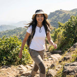 Venzina Outdoor Sun Hat worn by woman hiking on a mountain trail showing wide brim and adjustable chin strap