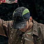 Venzina Quick Dry Cap worn outdoors with water poured over the fabric showing water-repellent surface