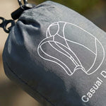 Venzina compact foldable backpack pouch, gray fabric logo close-up