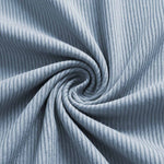 Venzina mens nightwear fabric close-up, light blue ribbed knit shown twisted to highlight texture and stretch details