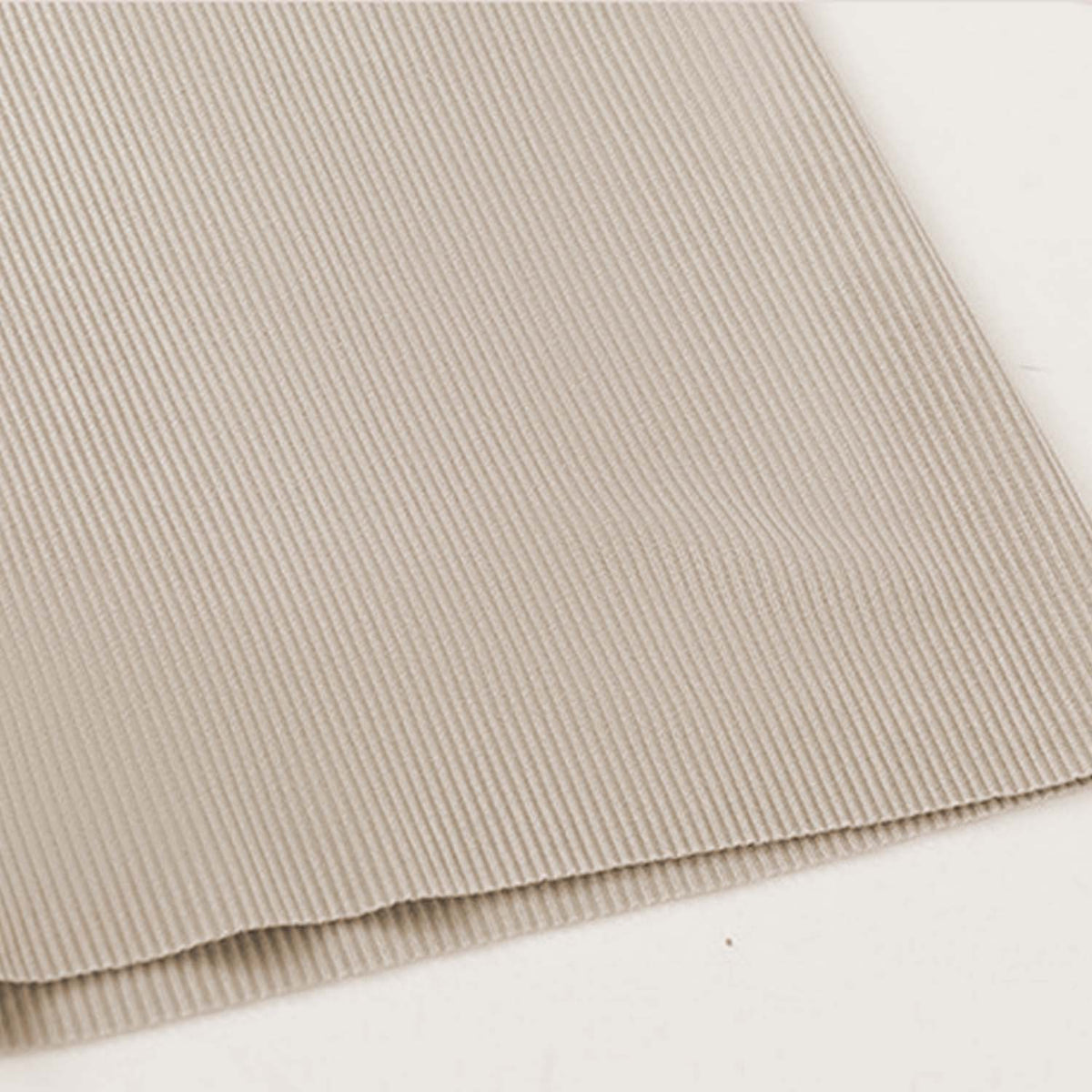 Venzina mens pyjamas close-up of beige ribbed fabric laid flat, showing fine knit texture and clean hem edge