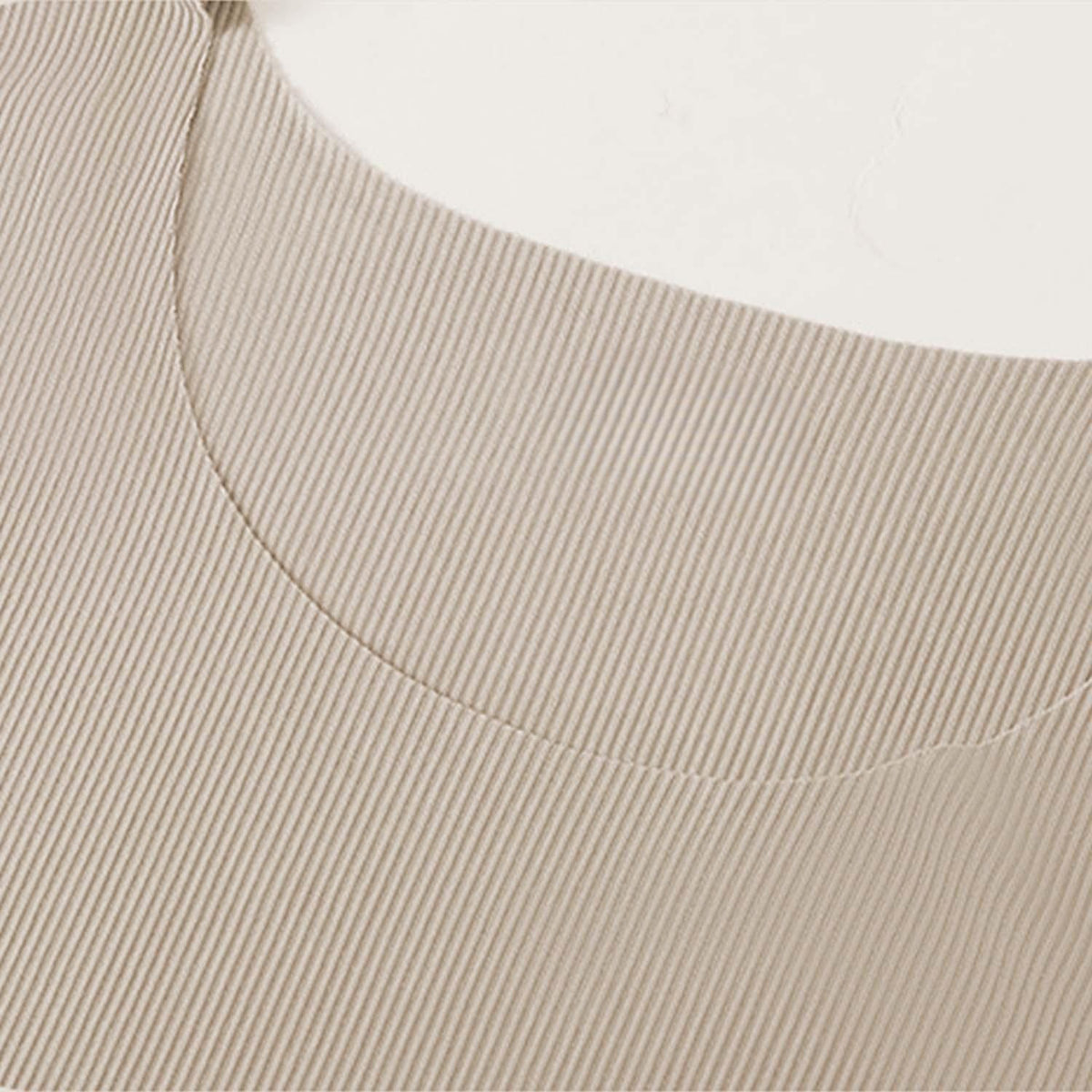 Venzina night suit for men close-up of beige ribbed neckline, showing seamless stitching and fine knit texture on flat surface