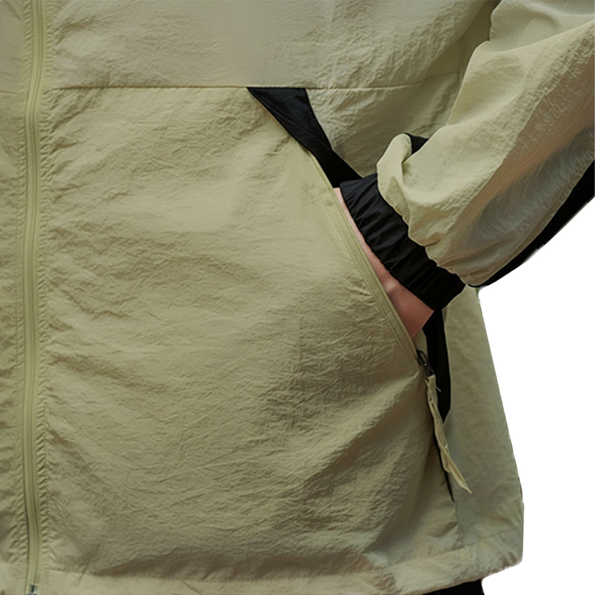 Venzina sun protection jacket close-up, olive fabric texture with zip pocket and black cuff, white background