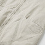 Venzina sun protection jacket women close-up pocket detail, beige fabric showing front zipper alignment and clean stitching on lightweight material