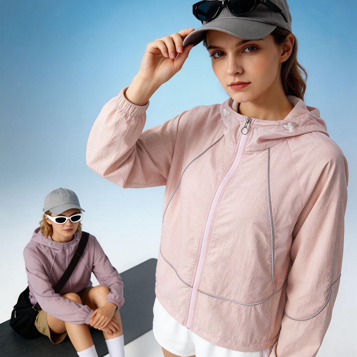 Venzina sun protection jacket women in blush pink, 3/4 close-up wearing cap with sunglasses, blue sky backdrop