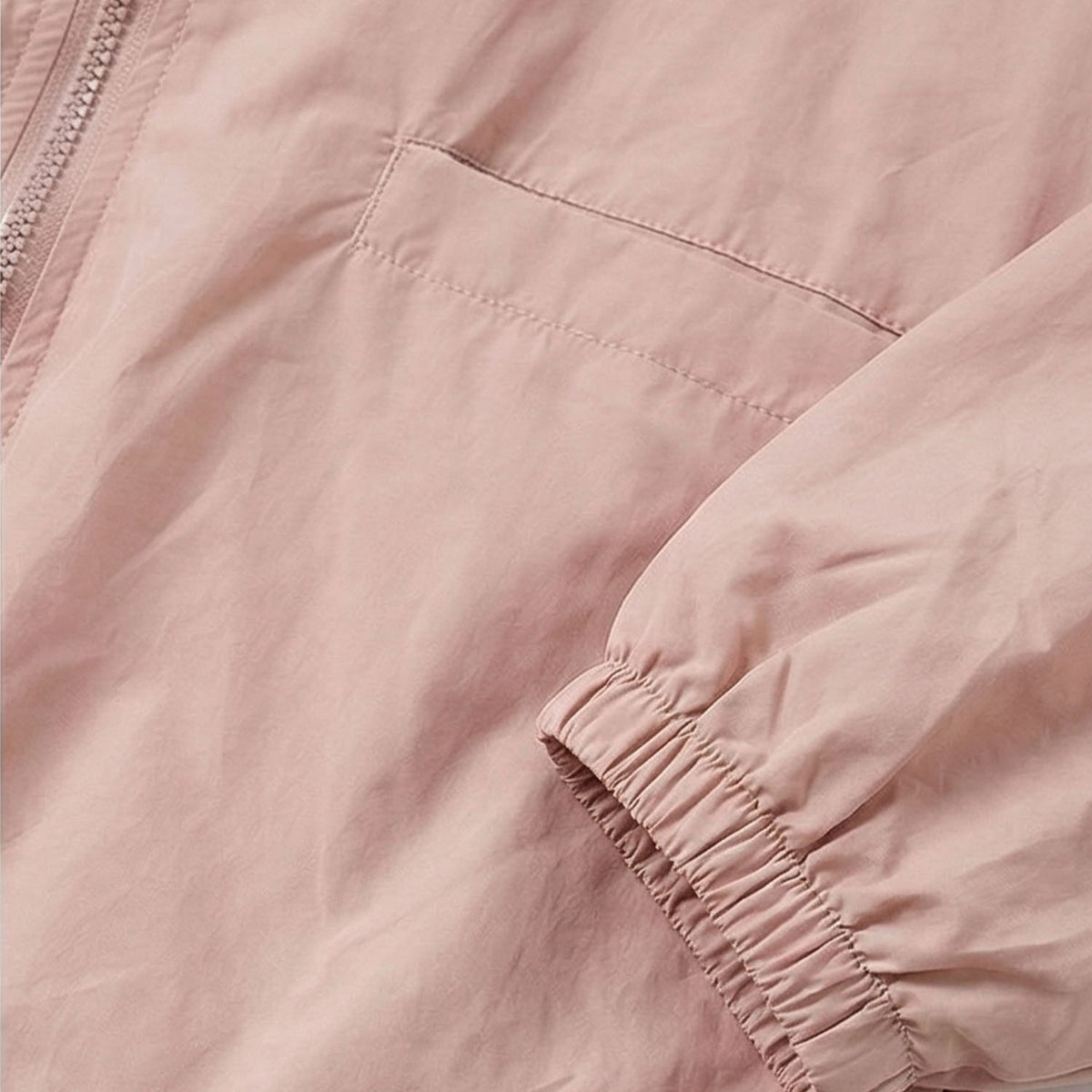 Venzina women's sun protection jacket close-up, soft pink fabric showing elastic cuff structure and fine stitching detail on sleeve