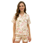 Woman wearing a floral women’s night suit, front view on white background