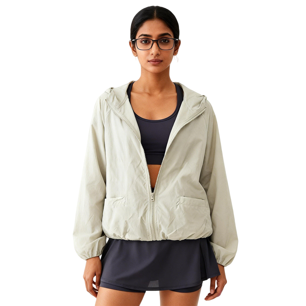 sun protection jacket women worn front view, light gray hooded zip jacket layered over black athletic outfit on white background