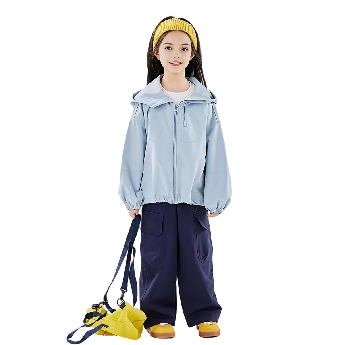 Girl wearing a light blue kids outdoor jacket with hood, navy pants, and yellow bag — breathable windbreaker jacket for everyday wear.