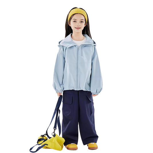 Girl wearing a light blue kids outdoor jacket with hood, navy pants, and yellow bag — breathable windbreaker jacket for everyday wear.