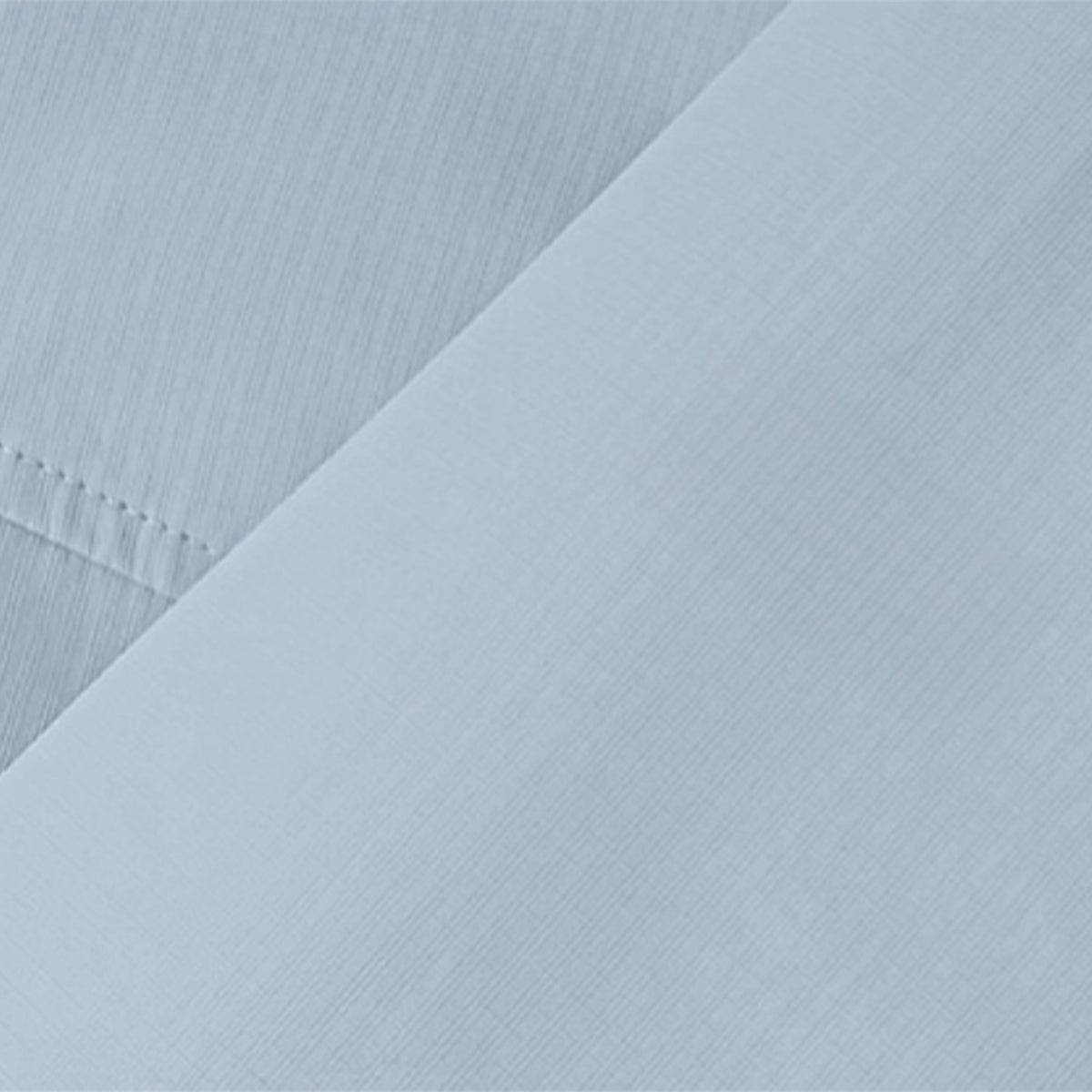 Close-up of light blue fabric from Venzina kids outdoor jacket — breathable, water-resistant windbreaker material showing fine weave texture.