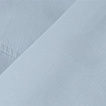 Close-up of light blue fabric from Venzina kids outdoor jacket — breathable, water-resistant windbreaker material showing fine weave texture.