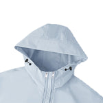 Close-up of light blue hooded kids outdoor jacket showing double-zip windbreaker design — breathable and water-resistant fabric on white background.