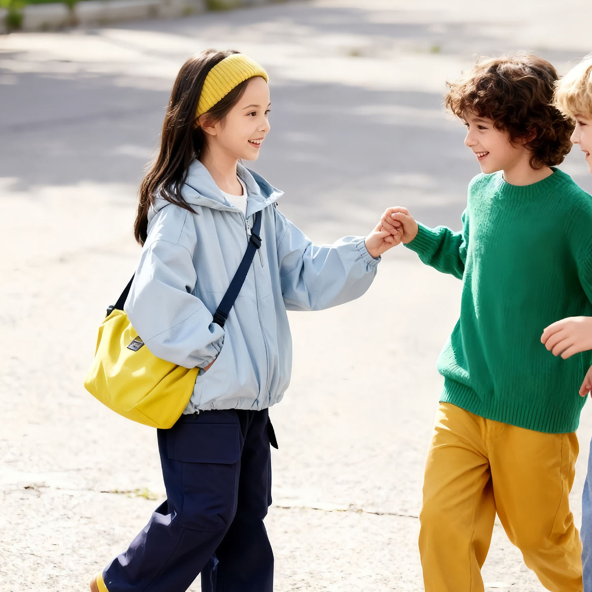 Girl wearing Venzina kids outdoor jacket walking with a friend outdoors — light blue windbreaker jacket styled for school and playtime.